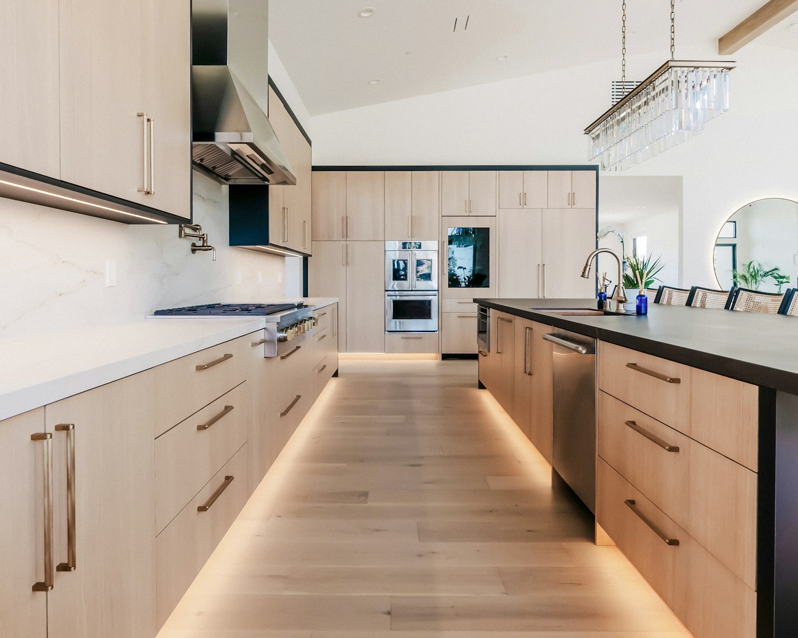 Kitchen with wood cabinetry and a light stone countertop
